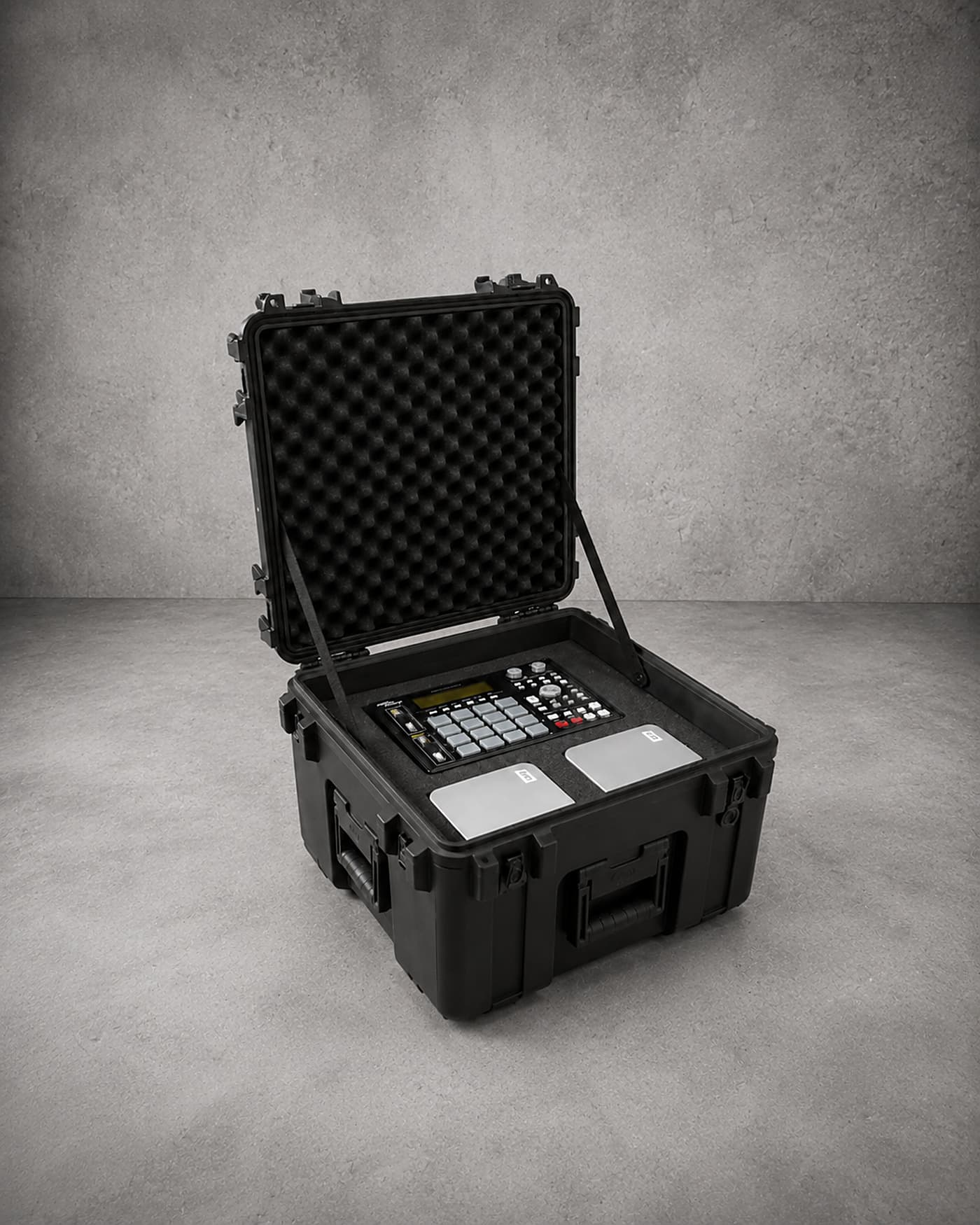 An open protective case with a custom foam insert cradling an electronic control unit
