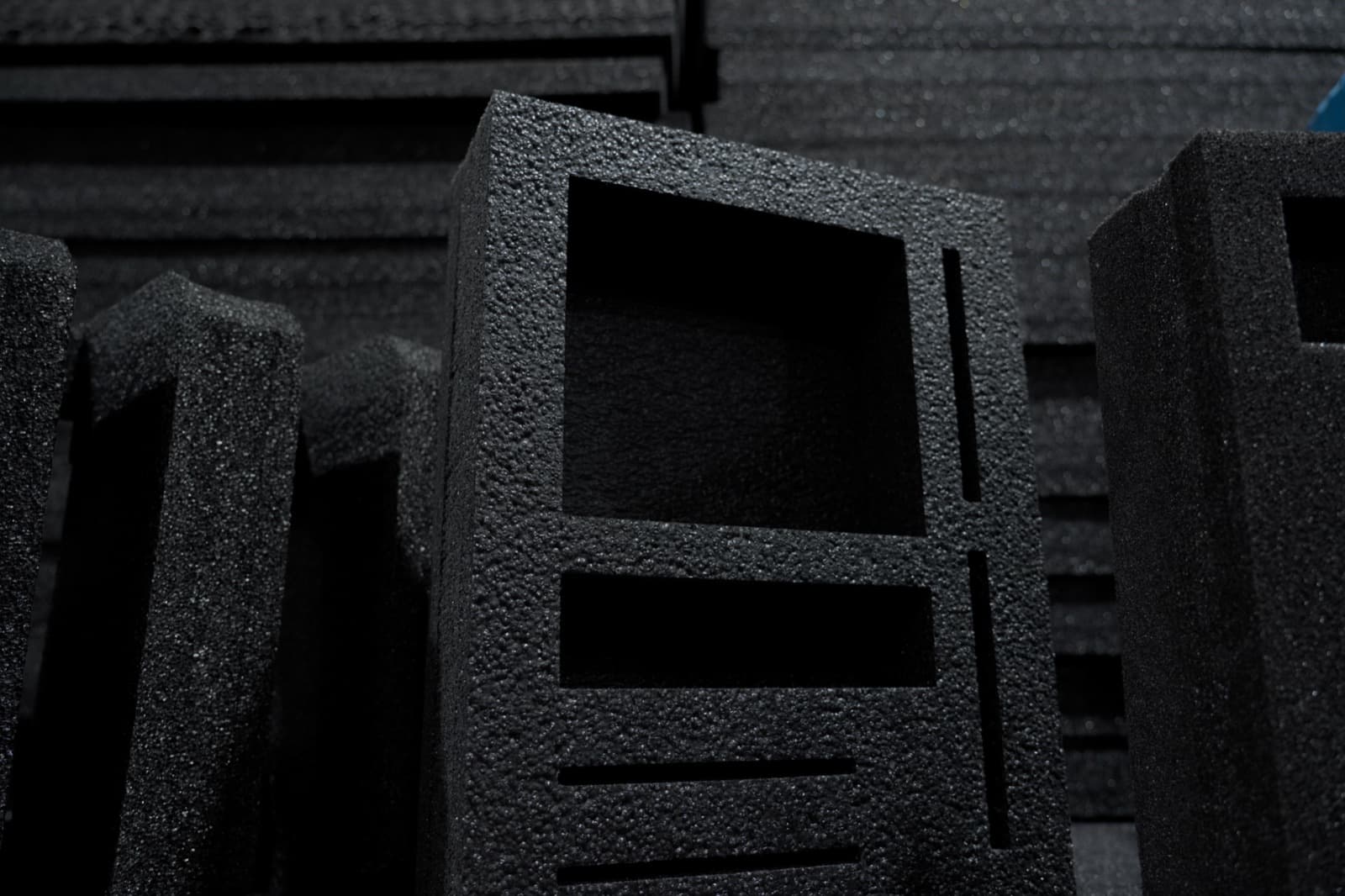 A precisely routed black foam case insert with rectangular cavities