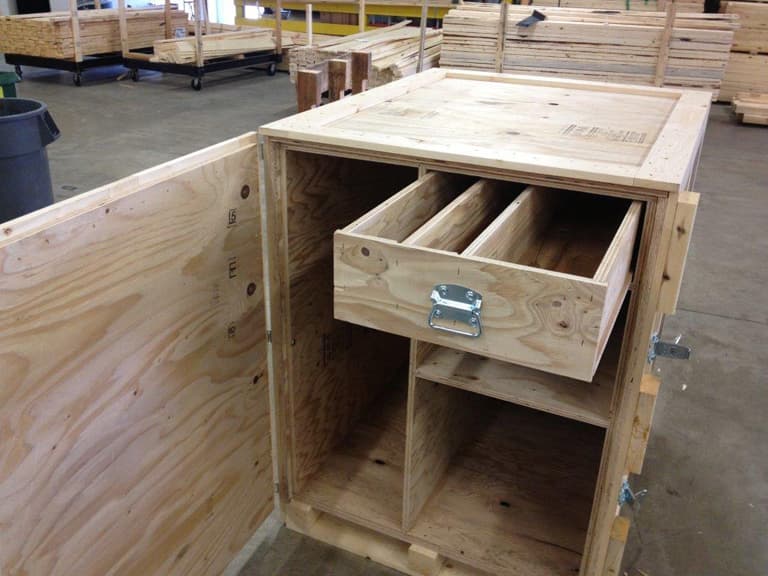 An open custom trade show crate with a hardware drawer and dividers